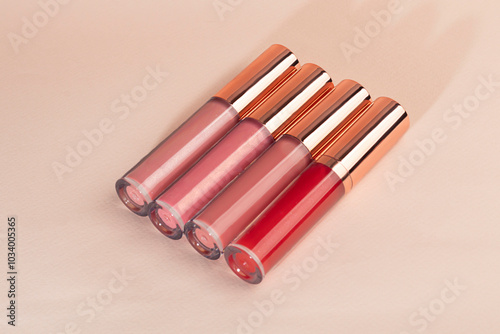 Lip gloss with applicator in light tubes. Cosmetic accessories.