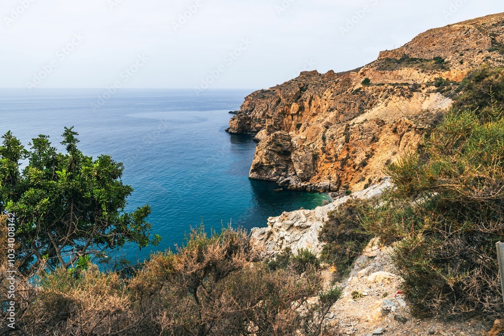 coastal view of rocky cliffs and blue sea with lush vegetation in Andalusian Granada in Spain coastal view of rocky cliffs and blue sea with lush vegetation in Andalusian Granada in Spain