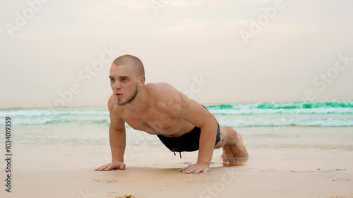 a man goes in for sports on the beach, push-ups on the sand