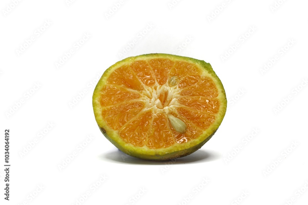 A close-up photo of a halved orange. The orange has a bright orange interior and a slightly green exterior. The photo is taken against a white background. A close-up photo of a halved orange. The orange has a bright orange interior and a slightly green exterior. The photo is taken against a white background.