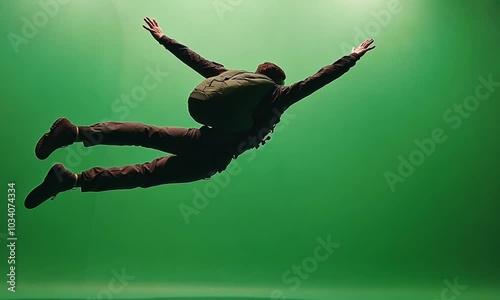 Skydiver in mid-air with green screen background