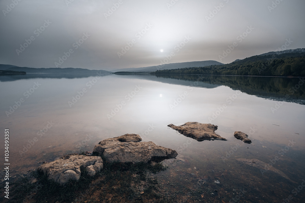 Sunrise on a mountain lake, cloudy weather, Shaori Reservoir Georgia Sunrise on a mountain lake, cloudy weather, Shaori Reservoir Georgia