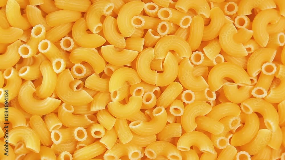 Uncooked Chifferi Rigati Pasta - Top View, Close-Up. Fat and Unhealthy Food. Classic Dry Macaroni, Slowly Rotating Background. Italian Culture and Cuisine. Raw Golden Pasta Texture - Right Rotation Uncooked Chifferi Rigati Pasta - Top View, Close-Up. Fat and Unhealthy Food. Classic Dry Macaroni, Slowly Rotating Background. Italian Culture and Cuisine. Raw Golden Pasta Texture - Right Rotation