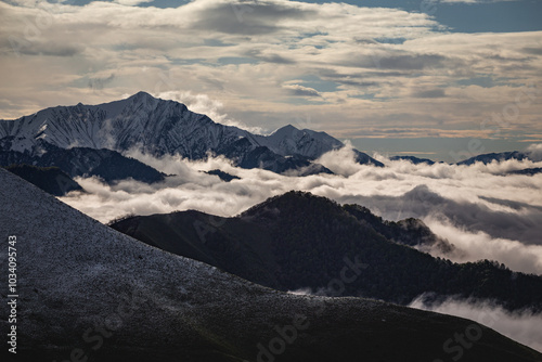 carpet of clouds in the mountains, snow line and mountain peaks