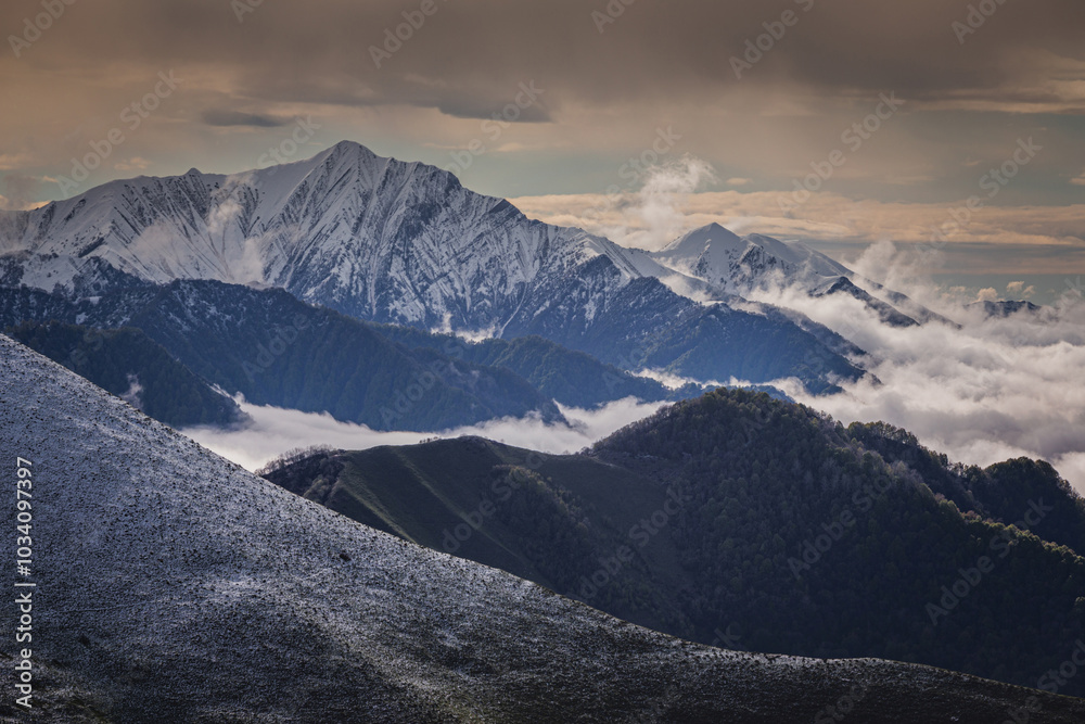 Fototapeta premium Snow-capped mountains with clouds, Caucasus mountains,