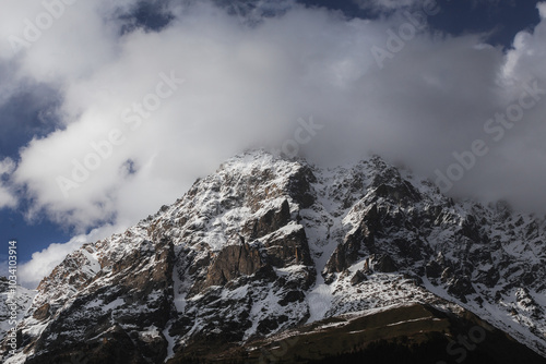 Snowy mountain peak in clouds, Mount Ushba in Georgia