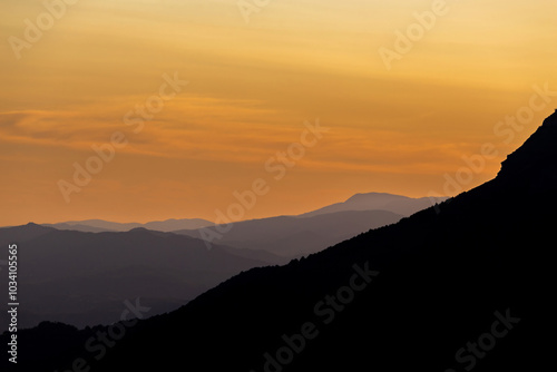 mountain ranges at sunset in the haze