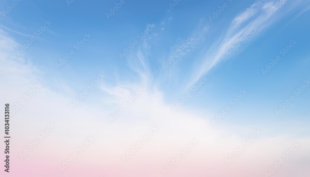 A clear blue sky with delicate white clouds against a soft pink horizon. A clear blue sky with delicate white clouds against a soft pink horizon.