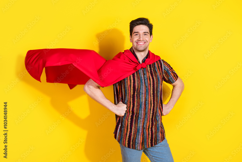 Photo of nice young man wear posing superhero costume isolated on yellow color background Photo of nice young man wear posing superhero costume isolated on yellow color background