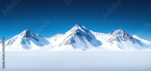 Majestic snow-covered mountains under a clear blue sky, breathtaking winter scenery.