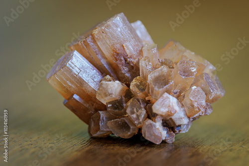 A small druse of aragonite lying on the table.
