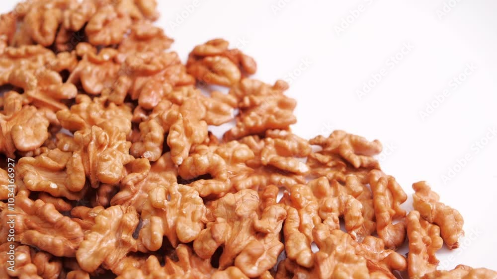 Walnut Halves Rotating on a White Background. Raw healthy ingredient Concept. Vegan Food Walnut Halves Rotating on a White Background. Raw healthy ingredient Concept. Vegan Food