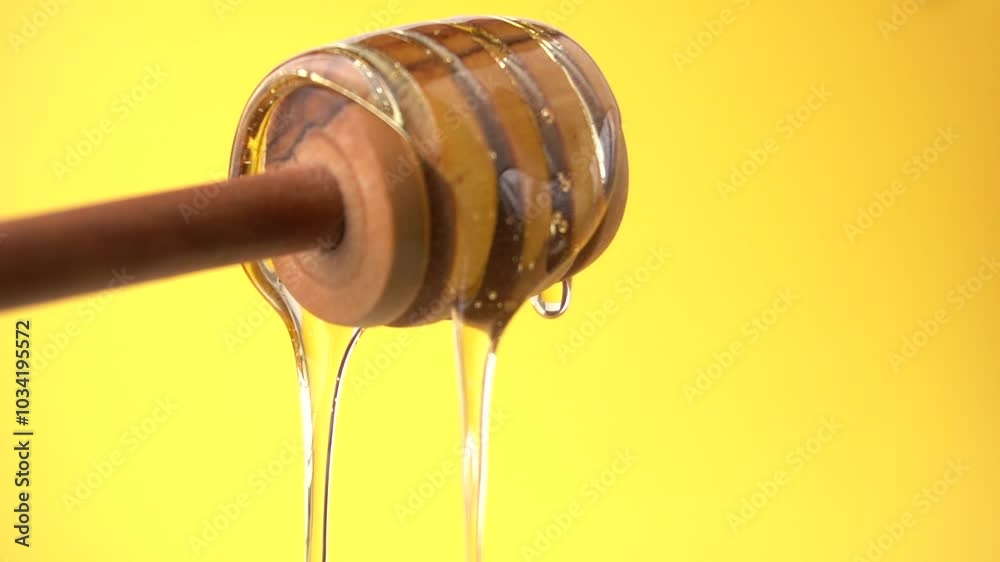 Flowing honey closeup on yellow backgrounds.