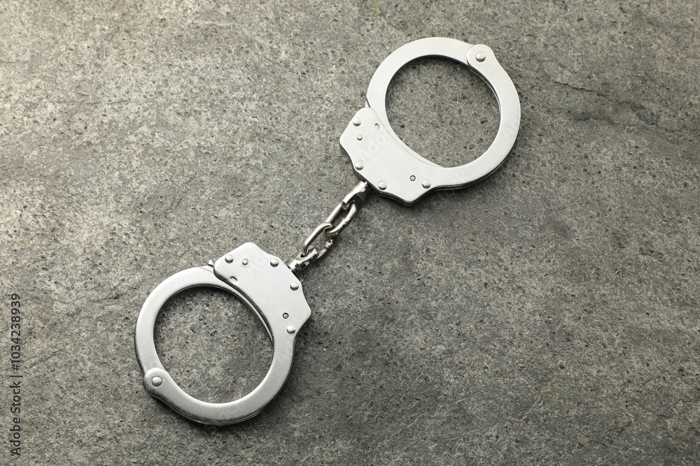 Classic chain handcuffs on grey table, top view Classic chain handcuffs on grey table, top view