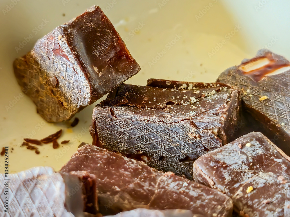 Close-up of delicious chocolate pieces captured on a neutral background, emphasizing the texture and richness of the chocolate. Perfect for food-related projects. Close-up of delicious chocolate pieces captured on a neutral background, emphasizing the texture and richness of the chocolate. Perfect for food-related projects.