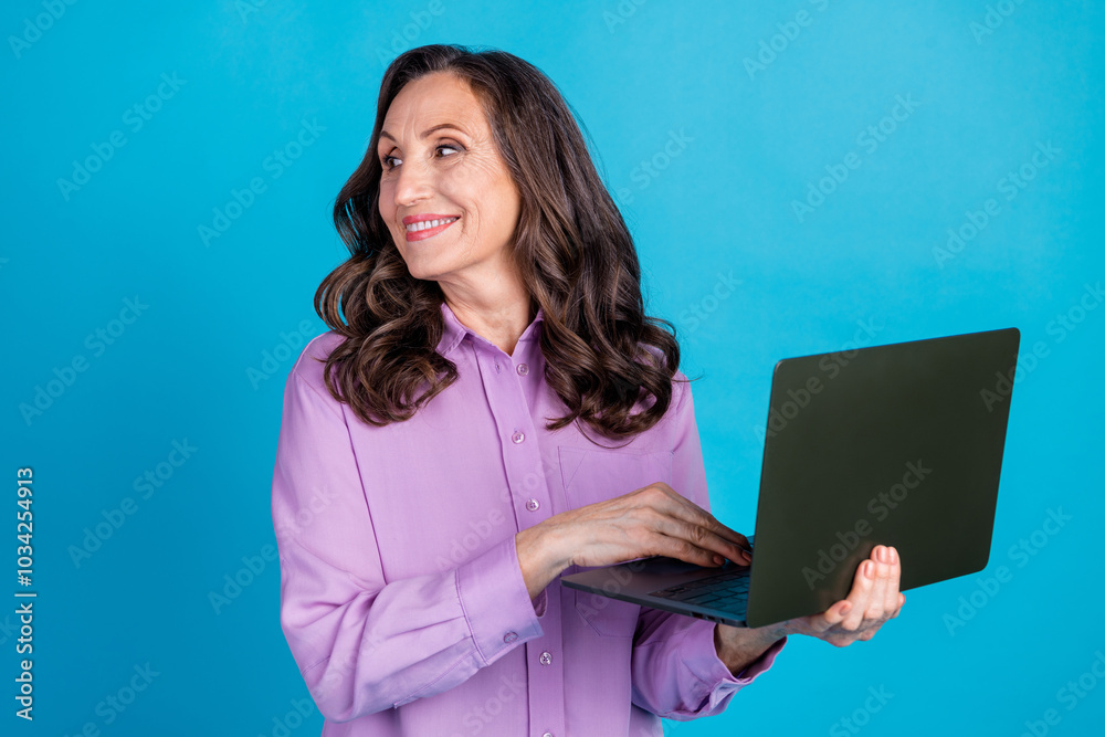 Photo of cheerful pretty lady dressed puple blouse texting modern gadget looking empty space isolated blue color background Photo of cheerful pretty lady dressed puple blouse texting modern gadget looking empty space isolated blue color background