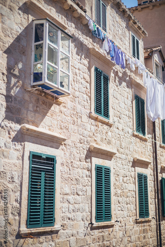 old house with green window shutters and clothes drying in the sun, Dubrovnik, Croatia