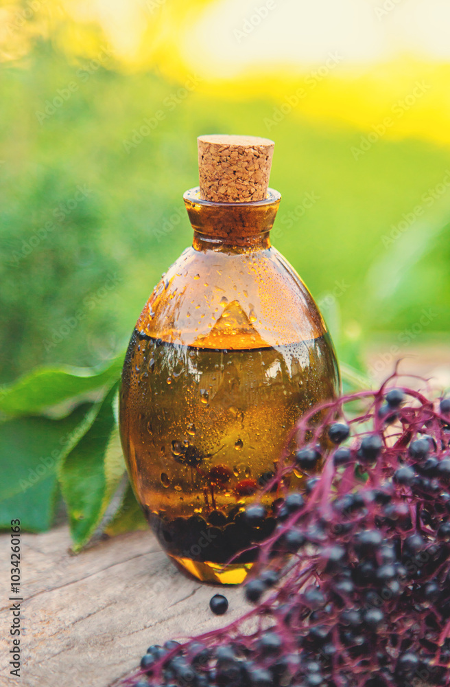 Flower and herbal extract in a bottle. Selective focus. Flower and herbal extract in a bottle. Selective focus.