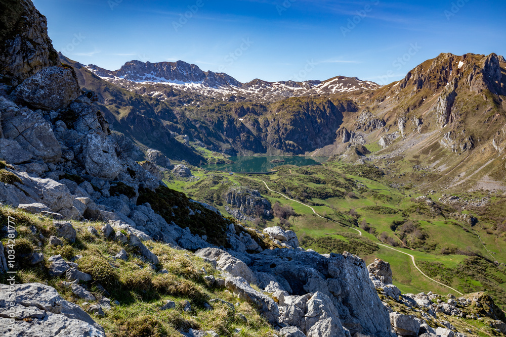 Panoramic view of the mountains of the Somiedo Natural Park in Asturias, Spain, with a spectacular view from the top in the middle of spring, snow on the peaks and grass in the valleys Panoramic view of the mountains of the Somiedo Natural Park in Asturias, Spain, with a spectacular view from the top in the middle of spring, snow on the peaks and grass in the valleys