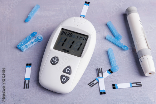 Close-up of a glucometer, test strips, and lancets on a concrete table, illustrating a glucose test setup in detail, showcasing health awareness