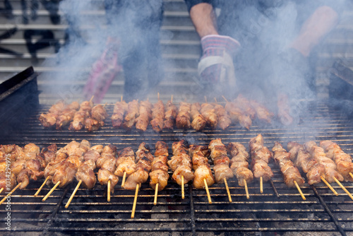 Fototapeta Naklejka Na Ścianę i Meble -  A grill filled with skewers of meat cooking