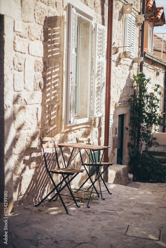 garden chairs and table on patio in backstreet of Old Town, Dubrovnik, Croatia