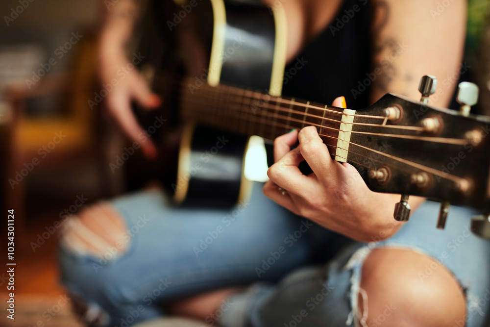 Fototapeta premium Person, hands and guitar in home for music, practice and learning chords on sofa. Musician, string instrument and strumming in living room with talent, pitch development and rehearsal for performance