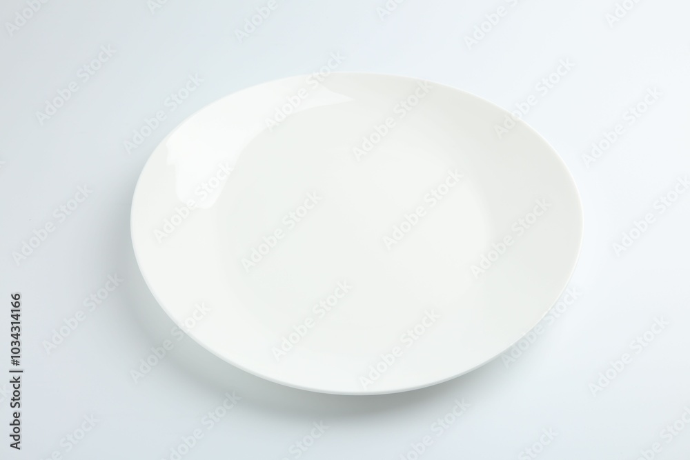 One empty ceramic plate isolated on white One empty ceramic plate isolated on white