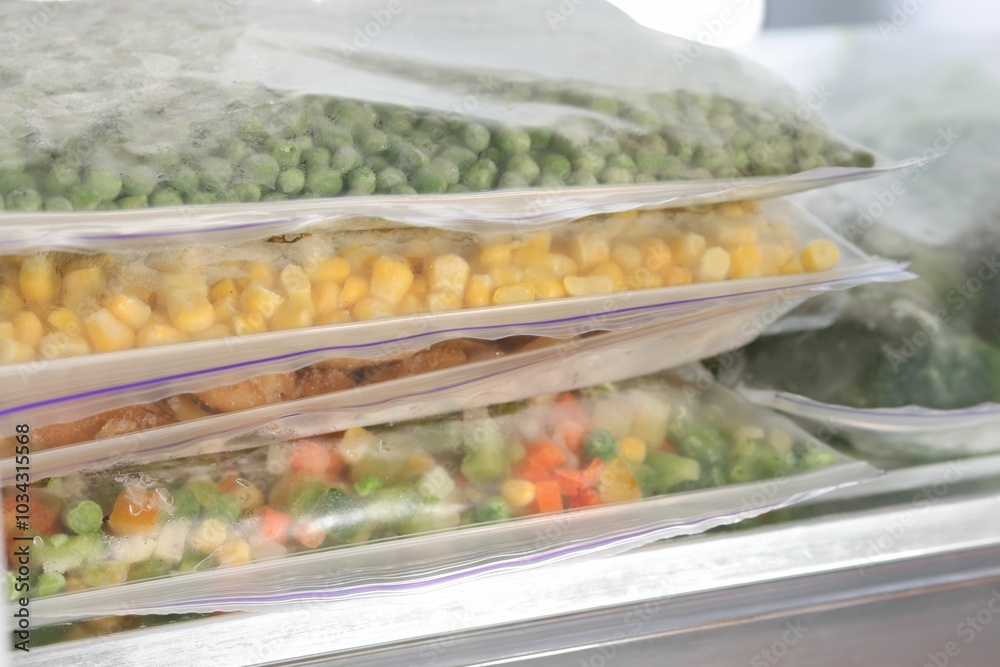 Plastic bags with different frozen vegetables in refrigerator, closeup Plastic bags with different frozen vegetables in refrigerator, closeup