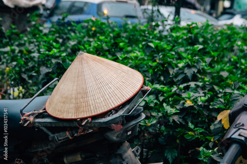 Traditional Vietnam hat non la on bike in Hanoi city