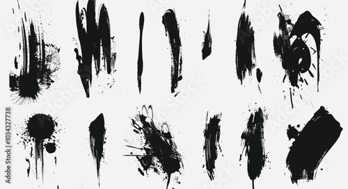 Abstract black paint splatters and brush strokes on a white background, showcasing a dynamic composition of artistic expressions.
