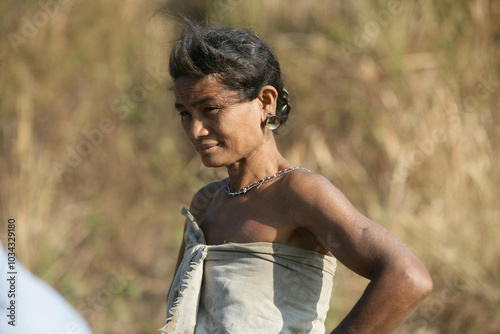 South asian poor rural tribal woman standing under mid say sun wearing a traditional costume  photo