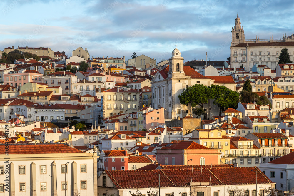 Fototapeta premium Panoramic Exposure done from a Cruise ship in the Cruise Ship terminal in Lisbon at Sunrise, of the Alfama neighborhood upon departure on the tagus river, Portugal