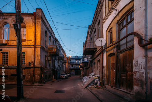 Old shabby houses in the slum district at Tbilisi at night photo