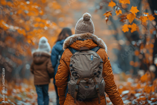 Friends enjoy a leisurely walk through a colorful autumn forest, surrounded by golden leaves and crisp air, wearing cozy jackets and backpacks on a tranquil day.