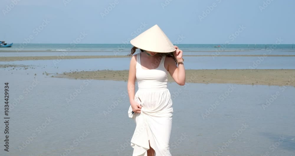 European girl in Vietnamese hat poses near paddy pond and girl photographer takes pictures European girl in Vietnamese hat poses near paddy pond and girl photographer takes pictures