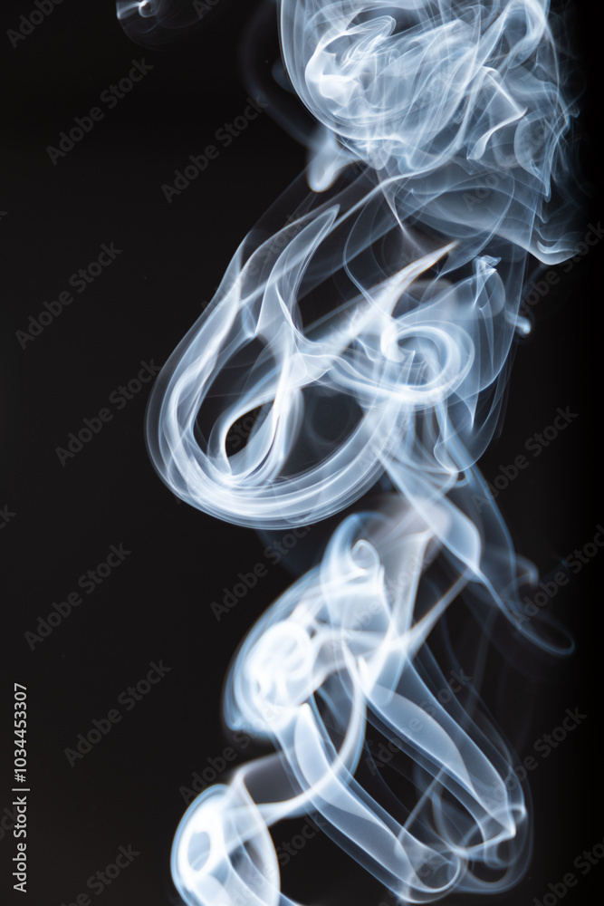 Swirling white smoke against a dark background, creating intricate patterns in a captivating display of movement and form Swirling white smoke against a dark background, creating intricate patterns in a captivating display of movement and form