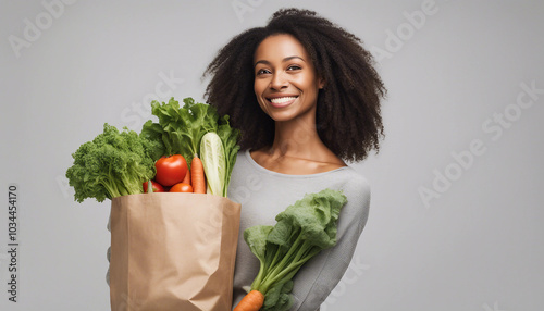 A woman holding a reusable shopping bag filled with fresh vegetables in an eco-friendly lifestyle scene.






 photo