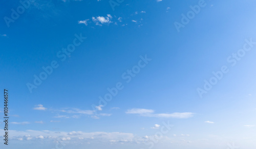 A clear blue sky with fluffy white clouds creates a serene atmosphere, perfect for relaxation and inspiration. Ideal for backgrounds or nature themes.