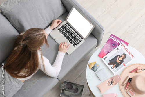Young woman with laptop sho...