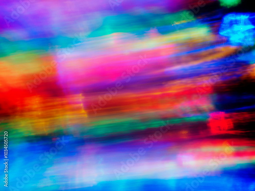 A colorful, blurry background with a rainbow of colors. The colors are bright and vibrant, creating a sense of energy and excitement. Abstract design wall paper. Cinematic light effect.