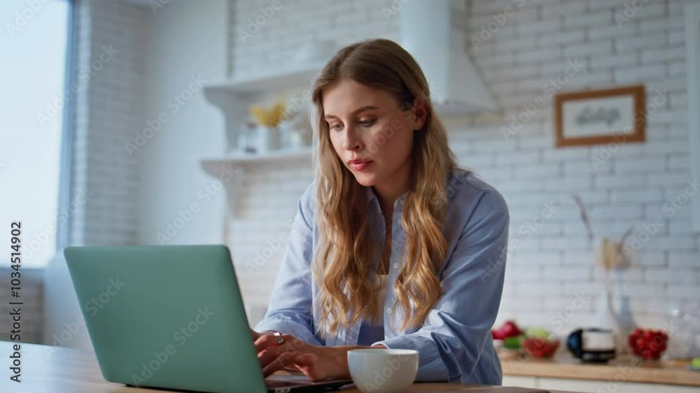 Online student drinking coffee at home kitchen closeup. Woman looking laptop Online student drinking coffee at home kitchen closeup. Woman looking laptop