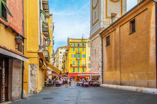 Фотография A lively afternoon at the Place Rossetti as tourists enjoy the cafes and shops in the colorful Vieux Old Town of Nice, France on the French Riviera