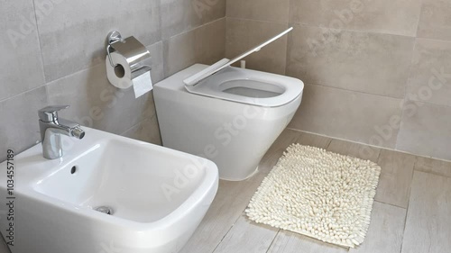 White ceramic toilet and bidet at luxury bathroom, nobody