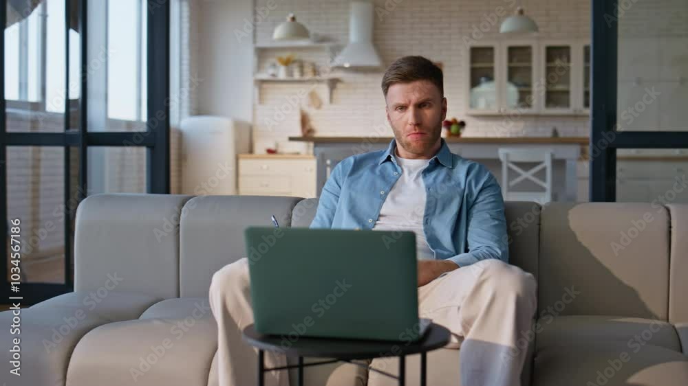Serious guy studying online sitting home with notebook closeup. Man writing Serious guy studying online sitting home with notebook closeup. Man writing