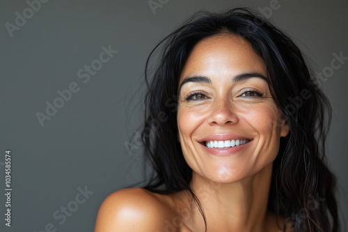 Beautiful middle age natural woman with perfect skin on neutral background with space for text, skincare concept