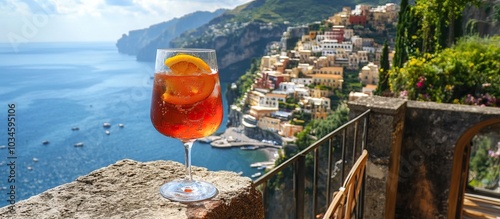 A glass of Aperol Spritz on a balcony overlooking the Amalfi Coast, Italy