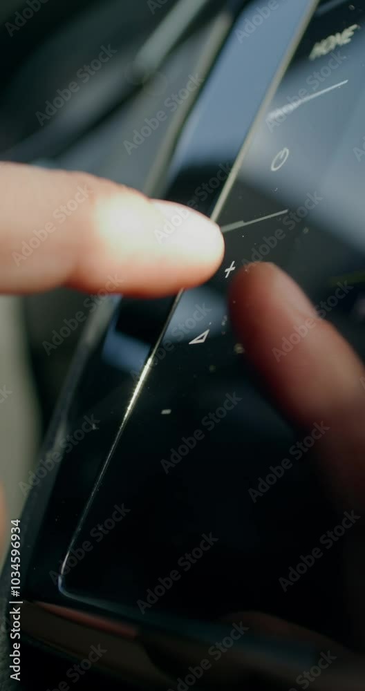 A man uses the control panel while driving a car. Close-up of his hands, an unrecognizable person. View from the car interior. A man uses the control panel while driving a car. Close-up of his hands, an unrecognizable person. View from the car interior.