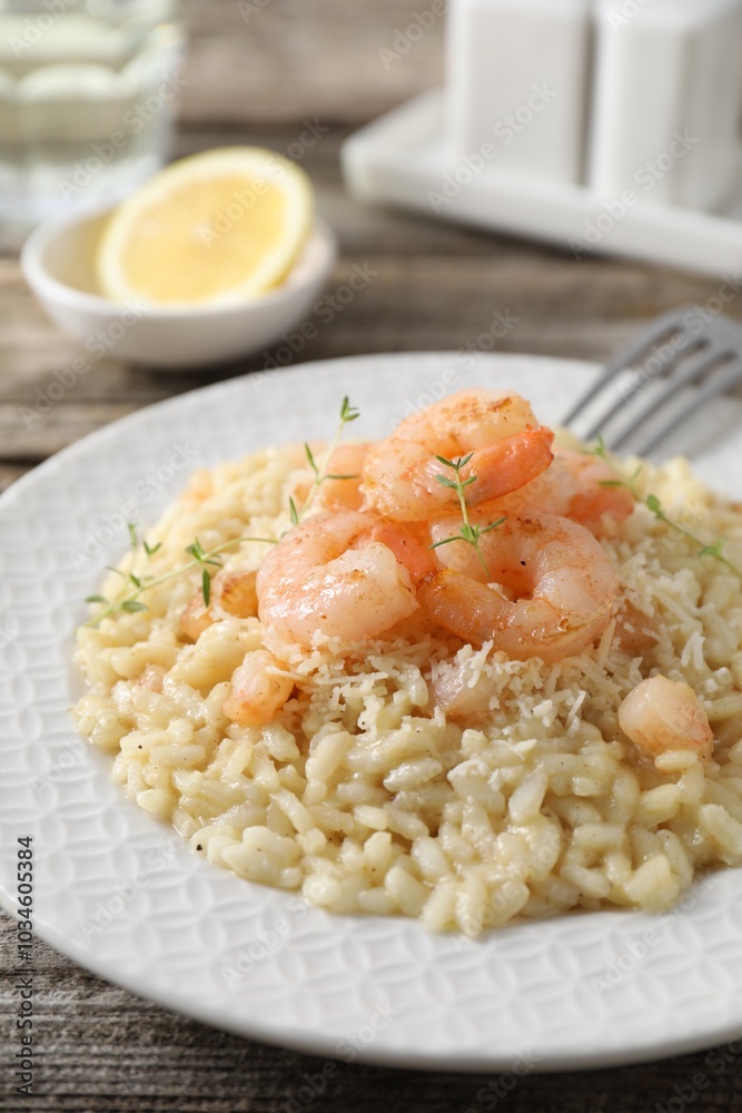 Delicious risotto with shrimps and cheese on wooden table, closeup Delicious risotto with shrimps and cheese on wooden table, closeup