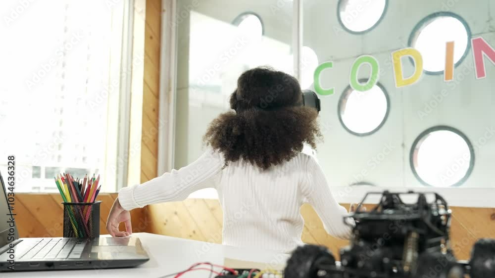 Smart african girl wearing VR vision glasses while touching around. Student study visual reality and holding hands in front. Child using technology gadget in online education in STEM class.Erudition. Smart african girl wearing VR vision glasses while touching around. Student study visual reality and holding hands in front. Child using technology gadget in online education in STEM class.Erudition.